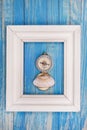 Old Compass in Photo frame on blue background Royalty Free Stock Photo