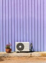 Old compressor air-conditioner and Flower Pot on zinc wall Royalty Free Stock Photo