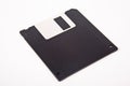 Old computer and data storage technology, black magnetic floppy disk 3ÃÂ½ inches, isolated on white background Royalty Free Stock Photo