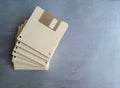 Old computer diskette, unlabeled, isolated, on a gray surface. Royalty Free Stock Photo