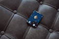 Hard disk drive laying on the grey leather sofa. Royalty Free Stock Photo