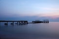 Old concrete bridges that melt on the beach by the sea in the morning, pastel tones, take long-exposure photos