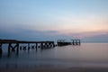 Old concrete bridges that melt on the beach by the sea in the morning, pastel tones, take long-exposure photos