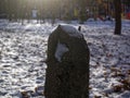 Old concrete column in snow in winter