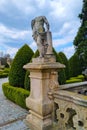 Old concrete sculpture without a head near the castle