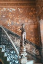 Old concrete shabby rounded staircase with a statue in an old Spanish-style colonial house Royalty Free Stock Photo