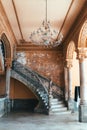 Old concrete shabby rounded staircase with a statue in an old Spanish-style colonial house Royalty Free Stock Photo