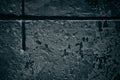 Old concrete wall with cruciform recess - dark grungy background