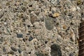 Old concrete wall with pieces of stones and cobbles background texture, weathered cement wall with pebble texture, grunge Royalty Free Stock Photo