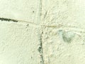 Old concrete wall with scratches, roughness and peeling paint surface, white, cream, light for background. Royalty Free Stock Photo