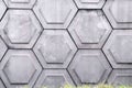 Old concrete wall texture with hexagon shape pattern white grey background with gree grass