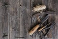 Old construction tools hammer, pliers, screwdriver, chisel lie on aged wooden boards of dark color with expressive texture