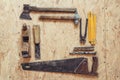 Old construction tools on a wooden workbench flat lay background. Carpenter table. Woodwork Royalty Free Stock Photo