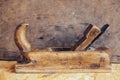 Old construction tools on a wooden workbench flat lay background with copy space. Old woodworking hand tool