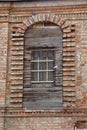 Old converted arched window in the monastery wall, red brick laying, background, Moscow 2021 Royalty Free Stock Photo