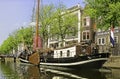 An old converted canal boat moored outside the Jenever museum in Schiedam Royalty Free Stock Photo