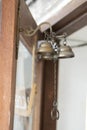Old copper bell on a wooden door Royalty Free Stock Photo