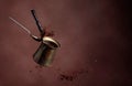 Old copper coffee maker and a spoon with ground coffee in motion Royalty Free Stock Photo