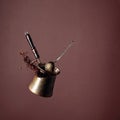 Old copper coffee maker and a spoon with ground coffee in motion Royalty Free Stock Photo