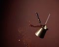 Old copper coffee maker and a spoon with ground coffee in motion Royalty Free Stock Photo