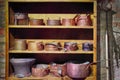 Old copper dishes on wooden shelves, vintage.