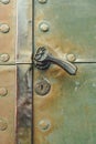 Old copper door with ornamented handle Royalty Free Stock Photo