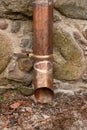 Old copper drain gutter in a brick building. Installation that drains water from the roof