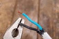 Old copper electric wire and combination pliers. Electrical installation repair