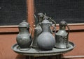 Old copper jug, ladle and bowl standing on a tray Royalty Free Stock Photo