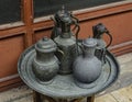 Old copper jug, ladle and bowl standing on a tray Royalty Free Stock Photo