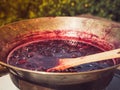 Old, copper pan, wooden spoon and plum jam Royalty Free Stock Photo