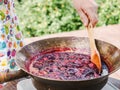 Old, copper pan, wooden spoon and plum jam Royalty Free Stock Photo