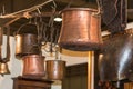 Old copper pots hanged on iron hooks
