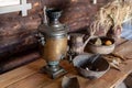 An old copper samovar on the table in a rural house. Royalty Free Stock Photo