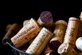 Old cork stoppers of French wines in a wire basket