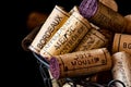 Old cork stoppers of French wines in a wire basket Royalty Free Stock Photo