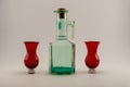 Old corked bottle and red shot glasses