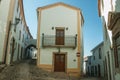 Old corner house with whitewashed wall in an alley of Marvao