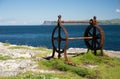 Old corroded iron winder with cogwheel, next to the sea, irish coast