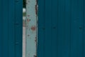 Old corrugated blue metal fence