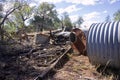 Old rainwater tanks and ruins of house. Royalty Free Stock Photo