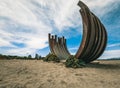 Old corten steel arc sculpture on the beach in Vancouver, Canada, in blue sky background