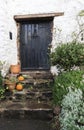 Old cottage door with pumpkins outside, Minehead, Somerset, UK Royalty Free Stock Photo