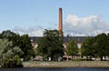 An old cotton mill stands on the banks of the Kokemaki River on a beautiful summer day