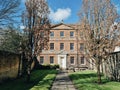 Old country house in Bury St Edmunds, England with a beautiful garden of bare trees and green grass Royalty Free Stock Photo