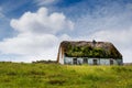 Old country house in a field on a warm sunny day, blue sky. Inishmore, Aran Islands, County Galway, Ireland. Irish landscape