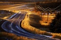 Old Country Road Turning Curved with Telephone Wires Glowing Golden Sunlight Royalty Free Stock Photo