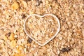 Old country style muesli background, heart-shaped bowl.