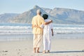 Old couple at beach, hug and travel with retirement and love outdoor, vacation with ocean view and relax in nature Royalty Free Stock Photo