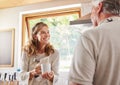 Old couple, coffee and conversation in home kitchen, drinking espresso or caffeine. Retirement, elderly man and woman